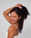 Woman with styled hair against a plain background