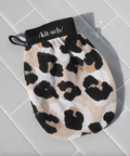 Leopard print mitt with 'kit-sch' branding on a tiled surface