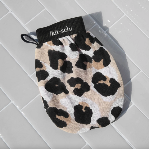 Leopard print mitt with 'kit-sch' branding on a tiled surface