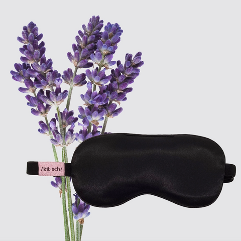 Black sleep mask with lavender flowers on a light gray background