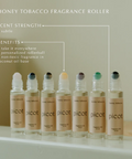 Row of picot honey tobacco fragrance roller bottles on a neutral background with product details.