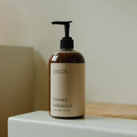 Skincare bottle labeled 'picot' on a white surface with a neutral background
