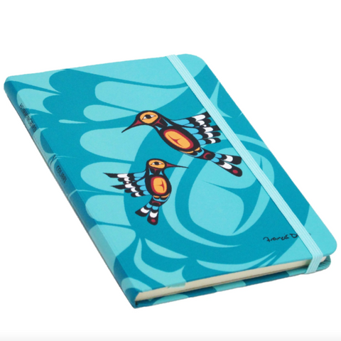 Blue notebook with bird design on a white background