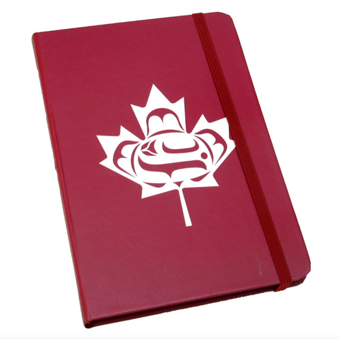 Red notebook with a white maple leaf design on a white background