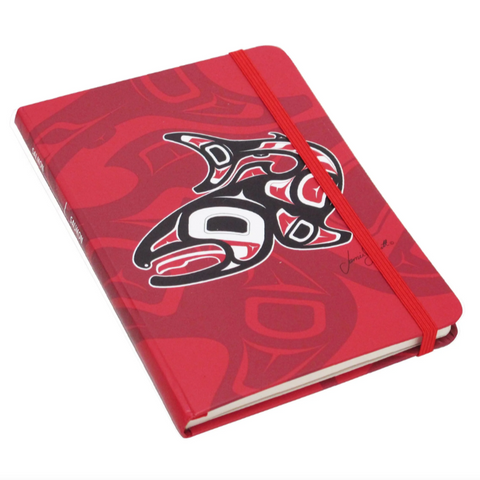 Red notebook with a black and white design on a white background