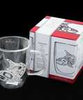Clear glass mug with salmon design next to its packaging box on a black background