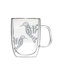 Clear glass mug with bird design on a white background