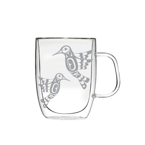 Clear glass mug with bird design on a white background