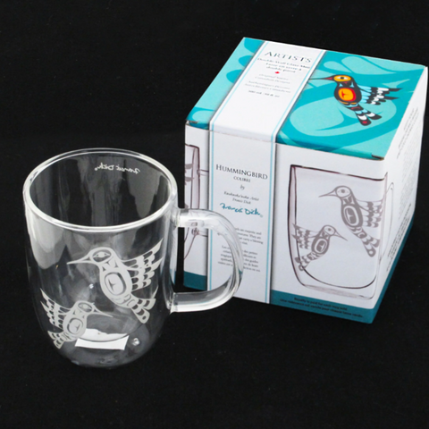 Clear mug with bird design and packaging on a black background