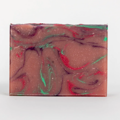 Swirled soap bar with red and green colors on a white background
