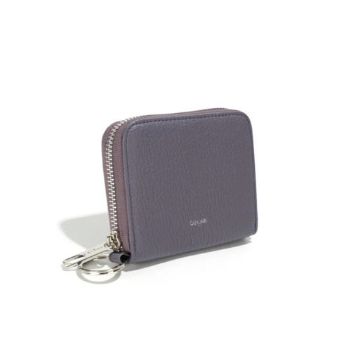 Purple wallet with keychain on a white background