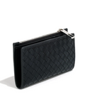 Black woven clutch bag on a white background with recycling and vegan label icons.