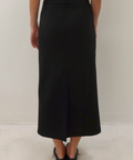 Person wearing a black skirt on a white background