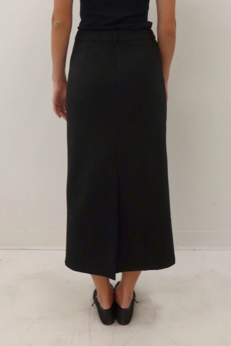 Person wearing a black skirt on a white background