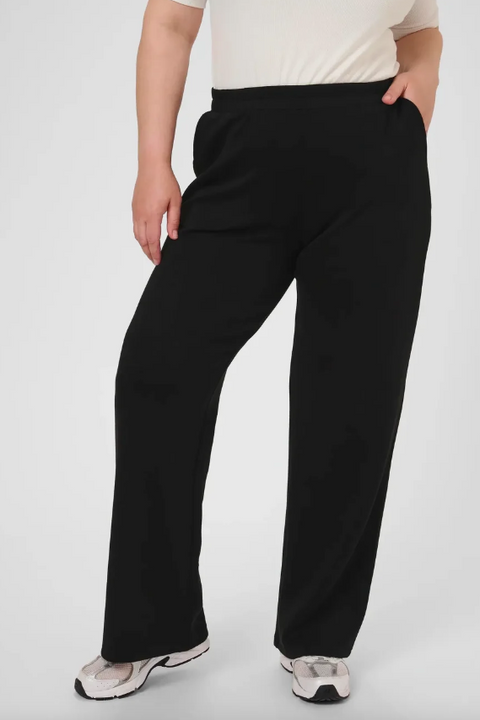 Person wearing black pants on a white background