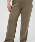 Brown pants worn by a person on a white background