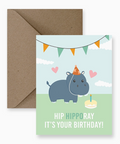 Birthday card with a hippo illustration and brown envelope on a white background