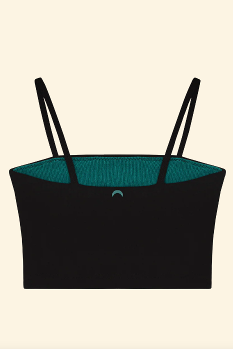 Black tank top with teal lining on a beige background