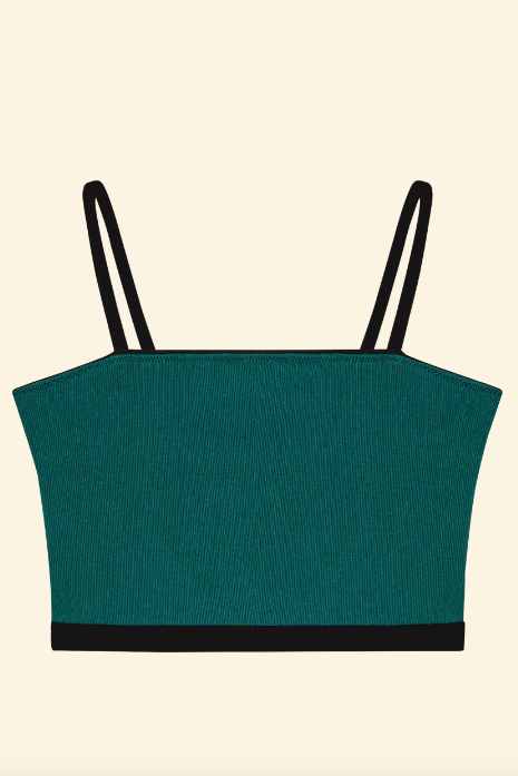 Green crop top with black straps on a beige background