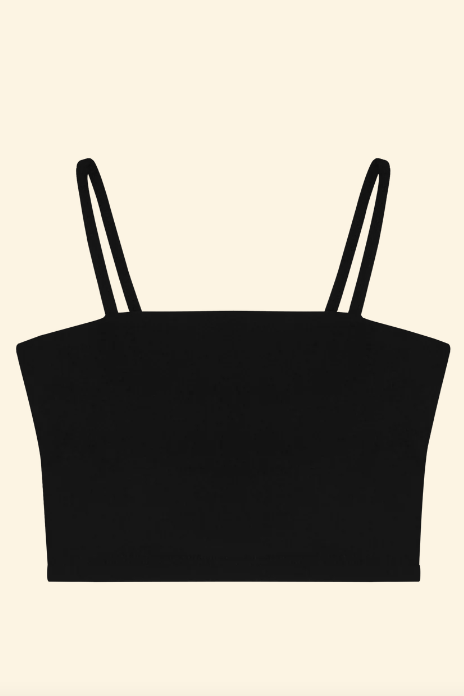 Black crop top with thin straps on a beige background