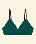 Green bralette with purple straps on a beige background