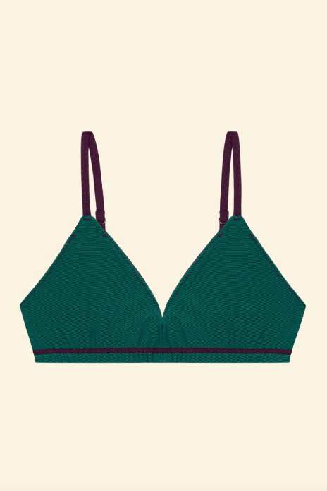 Green bralette with purple straps on a beige background