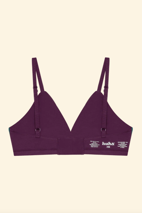 Purple bra with thin straps on a beige background