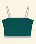 Green crop top with thin straps on a beige background