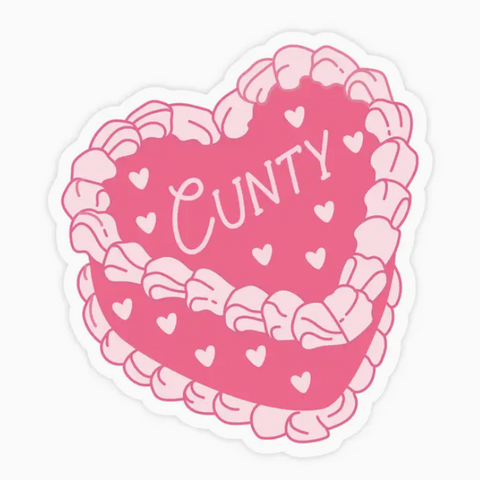 Heart-shaped pink cake with 'CUNTY' text on a white background