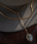 Necklace with a pendant on a textured surface
