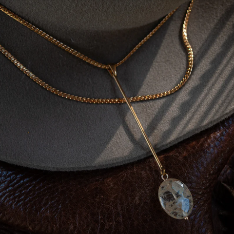 Necklace with a pendant on a textured surface