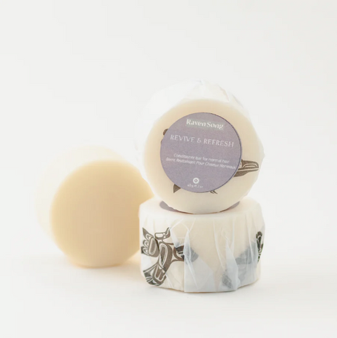 Two soap bars with labels on a white background