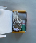 Product set with a jar, a bottle, and a box on a gray surface