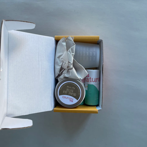Product set with a jar, a bottle, and a box on a gray surface