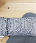 Gray patterned pouch with 'amma' branding on a wooden surface