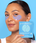 Woman holding a package of patchology eye gels with a blue background