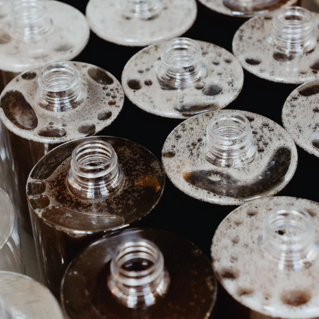 Close-up of metal bottle caps with a dark background