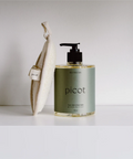 Picot hand soap bottle with a towel on a white background