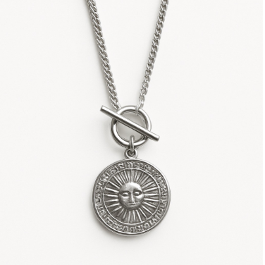 Silver necklace with a sun pendant on a white background