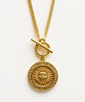 Gold necklace with a sun pendant on a white background