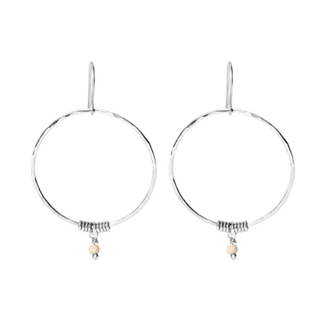 Pair of silver hoop earrings with small pink beads on a white background