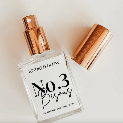 Perfume bottle labeled 'No. 3 Bisous' by Kindred Glow on a light background