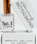 Perfume bottle labeled 'No. 3 Bisous' by Kindred Glow with packaging in the background.