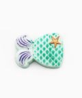 Decorative fish-shaped object with a star on a white background