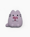 Plush toy resembling a cat with a pink heart on a white background