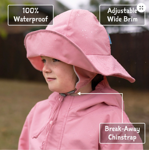 Child wearing a pink waterproof rain hat with features highlighted.