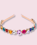 Multicolored gemstone headband on a light pink background