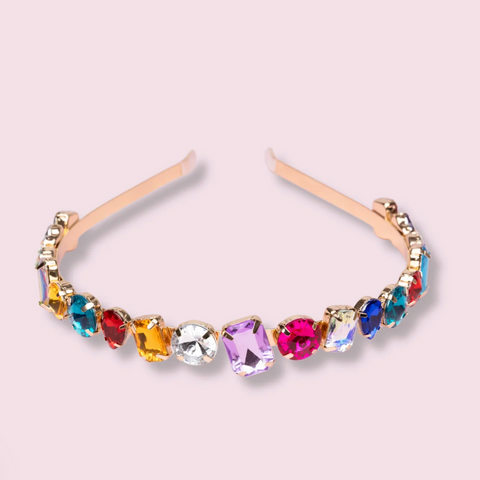 Multicolored gemstone headband on a light pink background