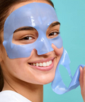 Woman wearing a blue face mask against a light blue background