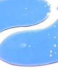 Blue paint swatch with white specks on a white background